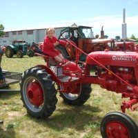 Poppy asks to sit on the red tractor