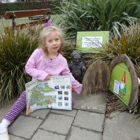 Poppy at the Botanical Gardens with her gnome-finding map ready to start the treasure hunt
