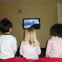 Joey, Poppy & Qing Qing watching How To Train Your Dragon in our motel room