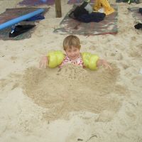 Digging herself into a sand hole